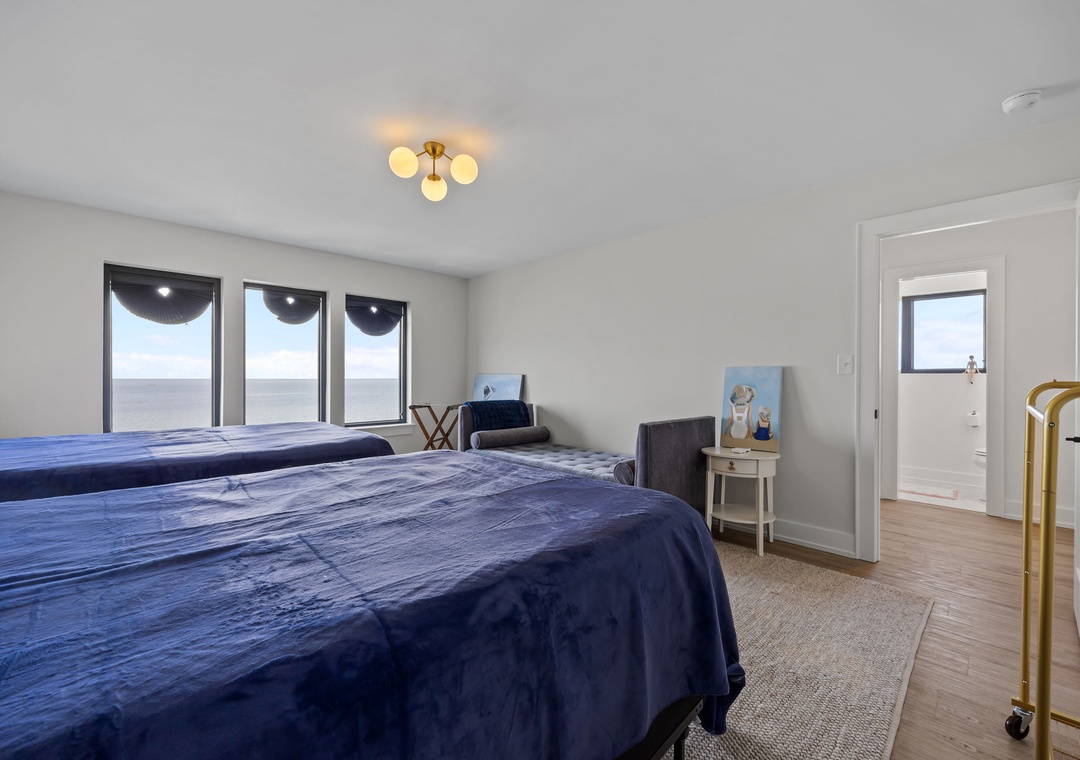 Drift off in your serene bedroom with panoramic windows framing endless views and elegant lighting creating the perfect ambiance.