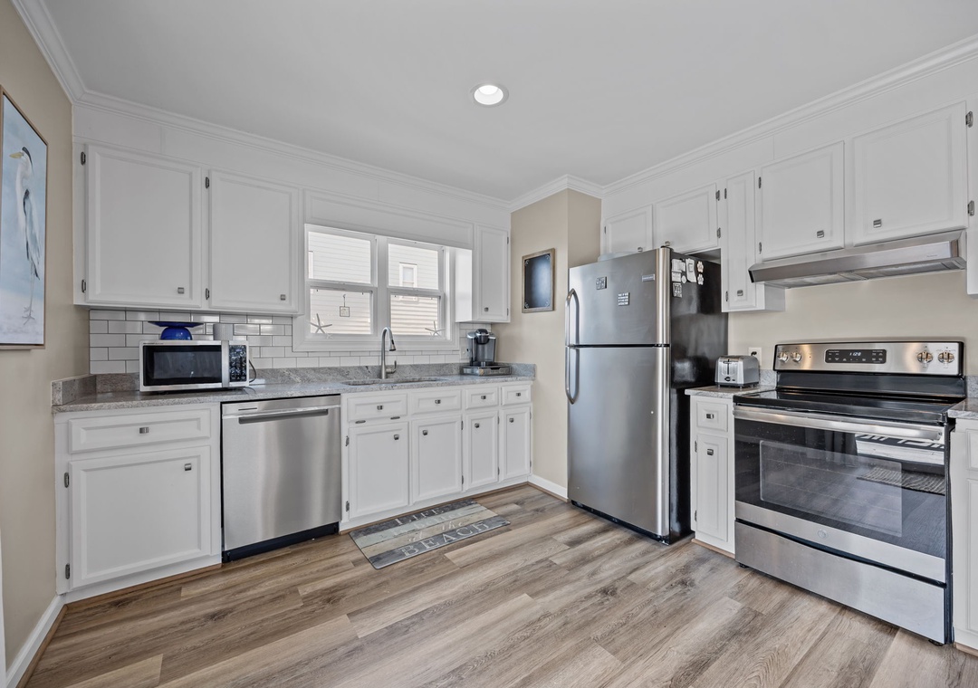 Your fully equipped kitchen features stainless steel appliances, granite countertops, and crisp white cabinetry for all your culinary adventures.