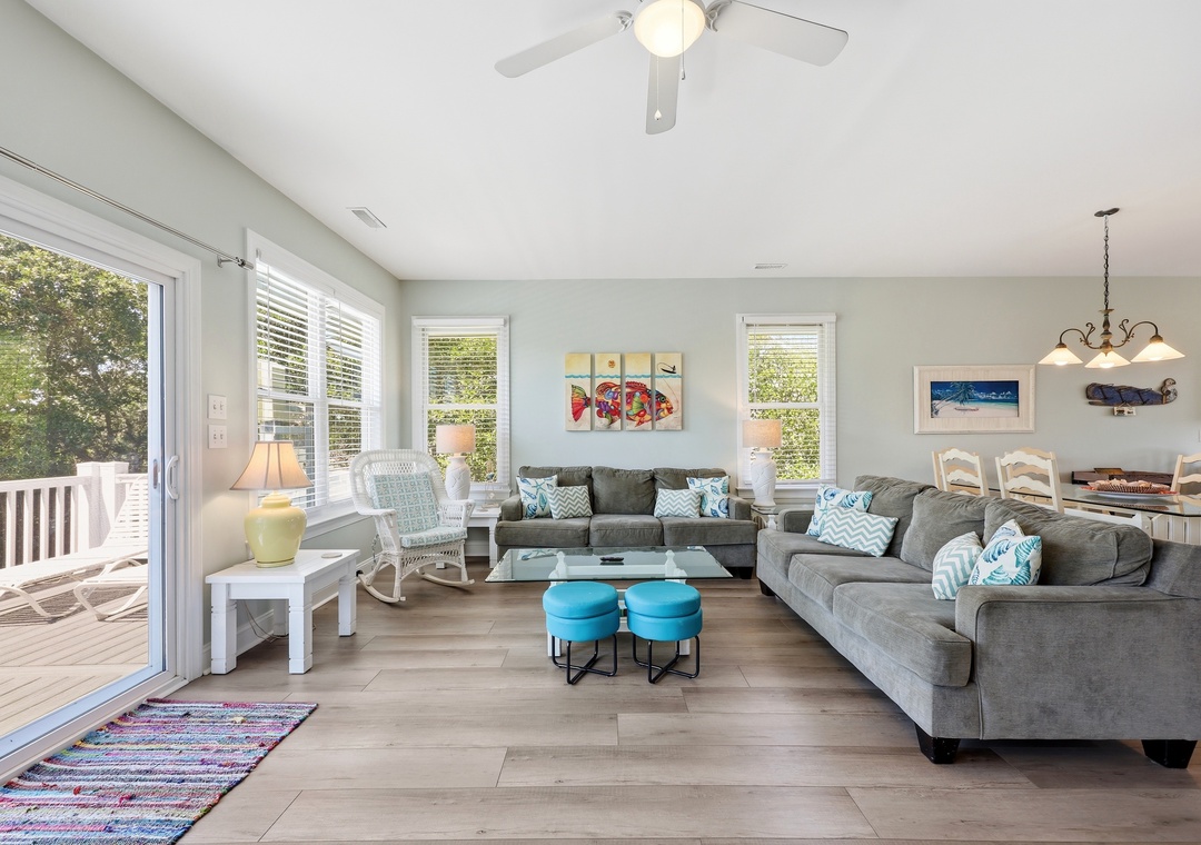 Sink into plush seating and feel the coastal breeze through open deck doors in your bright, airy living space—perfect for gathering after beach adventures.