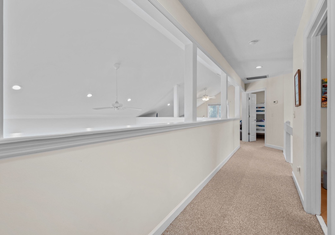 Walk through your bright, airy hallway with elegant white walls and soft carpeting beneath your feet.