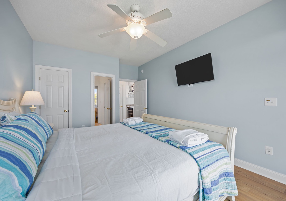 You'll drift off peacefully in this coastal-inspired bedroom with ocean-hued walls and crisp white linens awaiting your arrival.