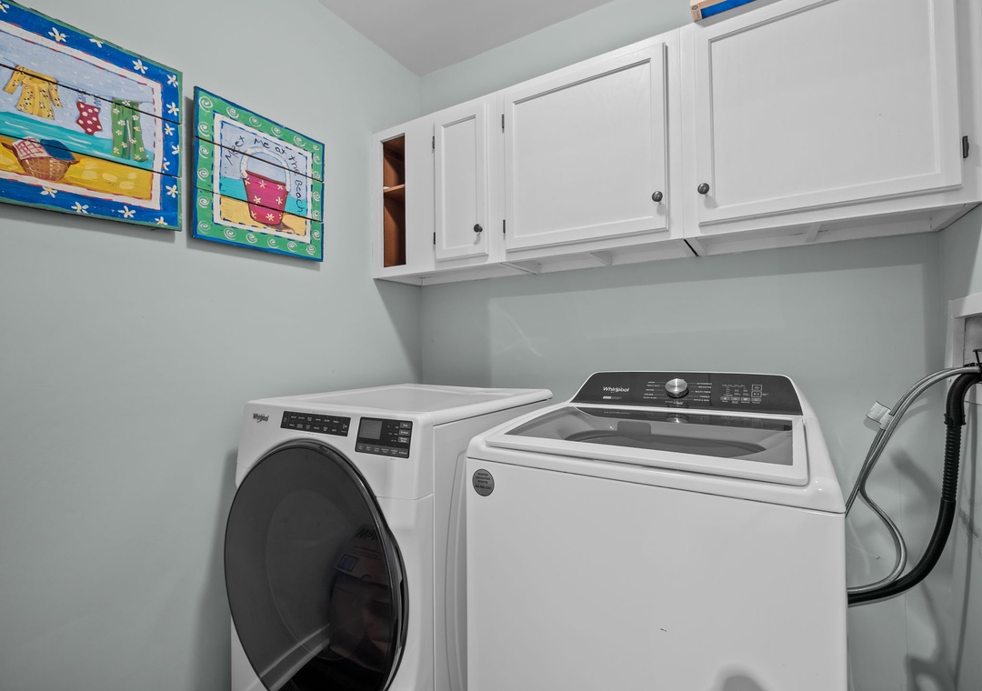 Keep your vacation wardrobe fresh in this dedicated laundry room with modern washer and dryer plus ample storage.