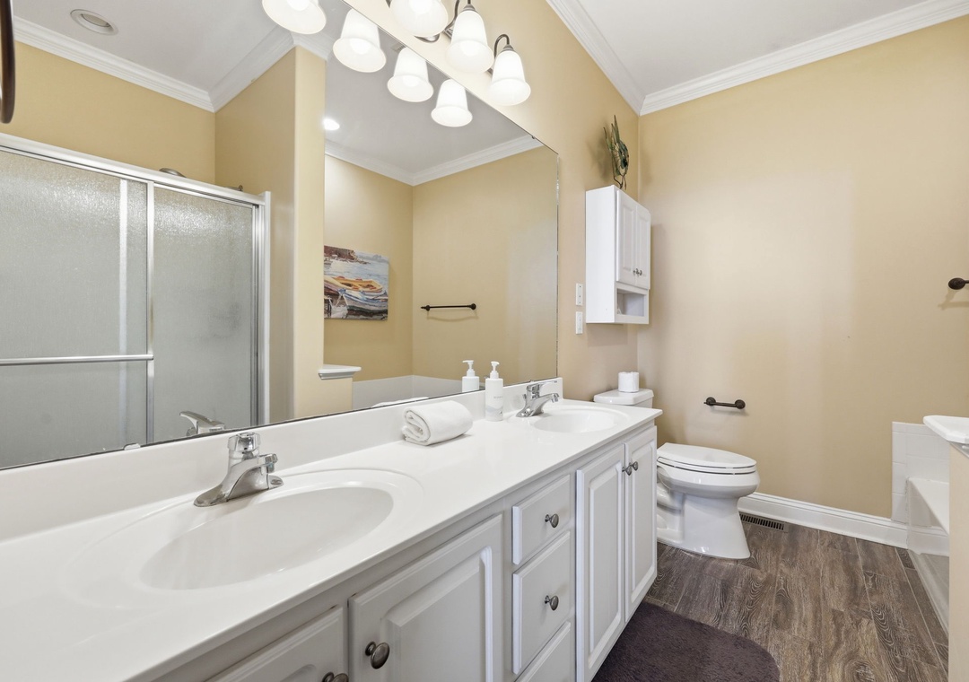 Freshen up in your spacious bathroom with dual sinks, a relaxing shower, and soft lighting—perfect for unwinding after a day of exploring.