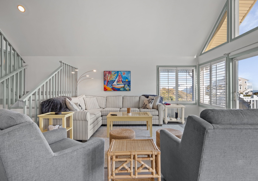 Relax in your bright, airy living space with plush seating and vibrant coastal artwork setting the perfect vacation mood.