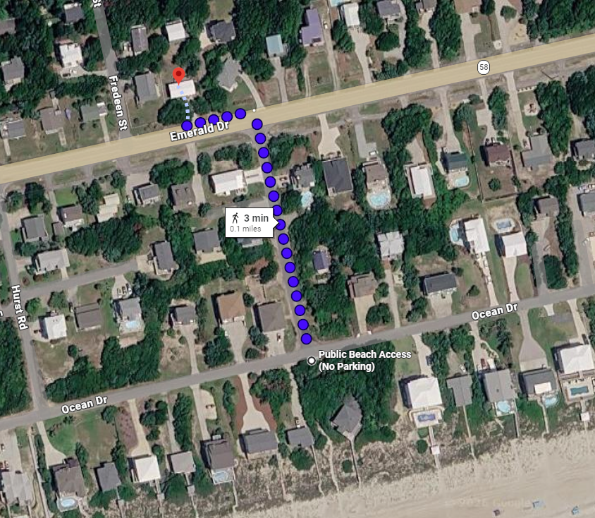 Aerial view of a residential coastal neighborhood showing nearby beach access, with the property located three minutes by foot from the ocean.