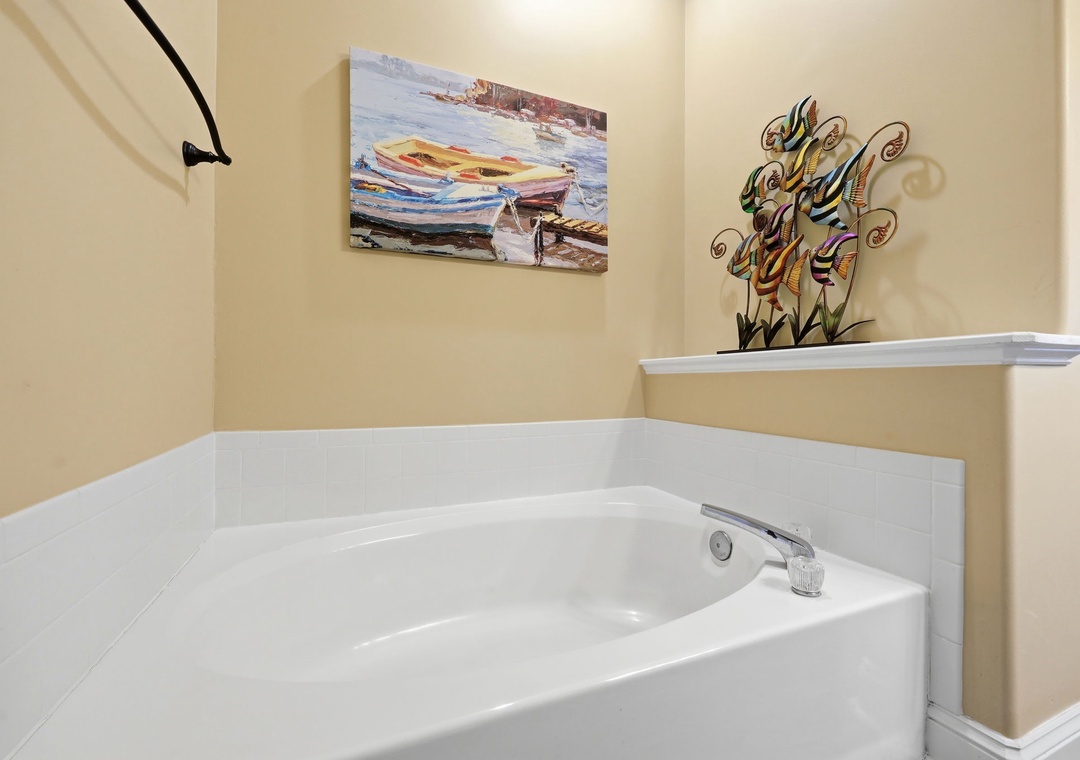 Slip into this inviting soaking tub where you'll melt away the day's adventures. The coastal artwork and warm tones create your private retreat for ultimate relaxation.
