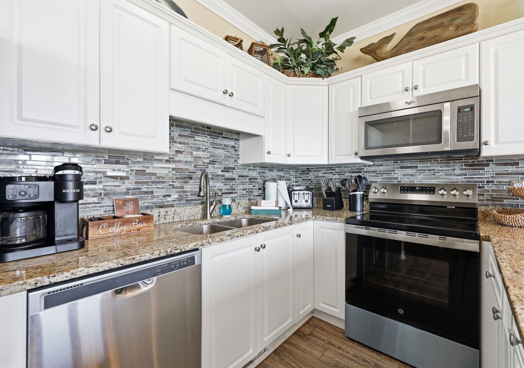 You'll love preparing meals in this bright, fully equipped kitchen with granite counters, modern appliances, and stylish backsplash—everything you need for a comfortable stay.
