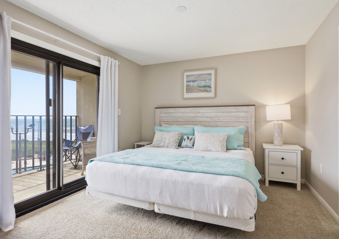 Wake up to ocean breezes and step right onto your private balcony. This coastal bedroom invites you to unwind with soft linens, soothing colors, and your morning coffee just beyond the door.