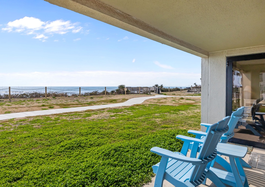 Covered patio with ocean views and comfortable seating for enjoying coastal breezes and scenic relaxation.