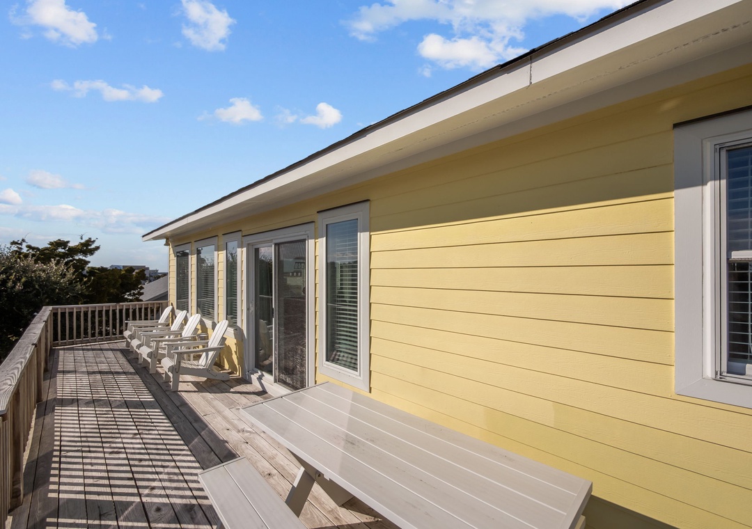 Your expansive deck beckons with weathered wood benches and Adirondack chairs, perfect for morning coffee or sunset wine while soaking in panoramic views.