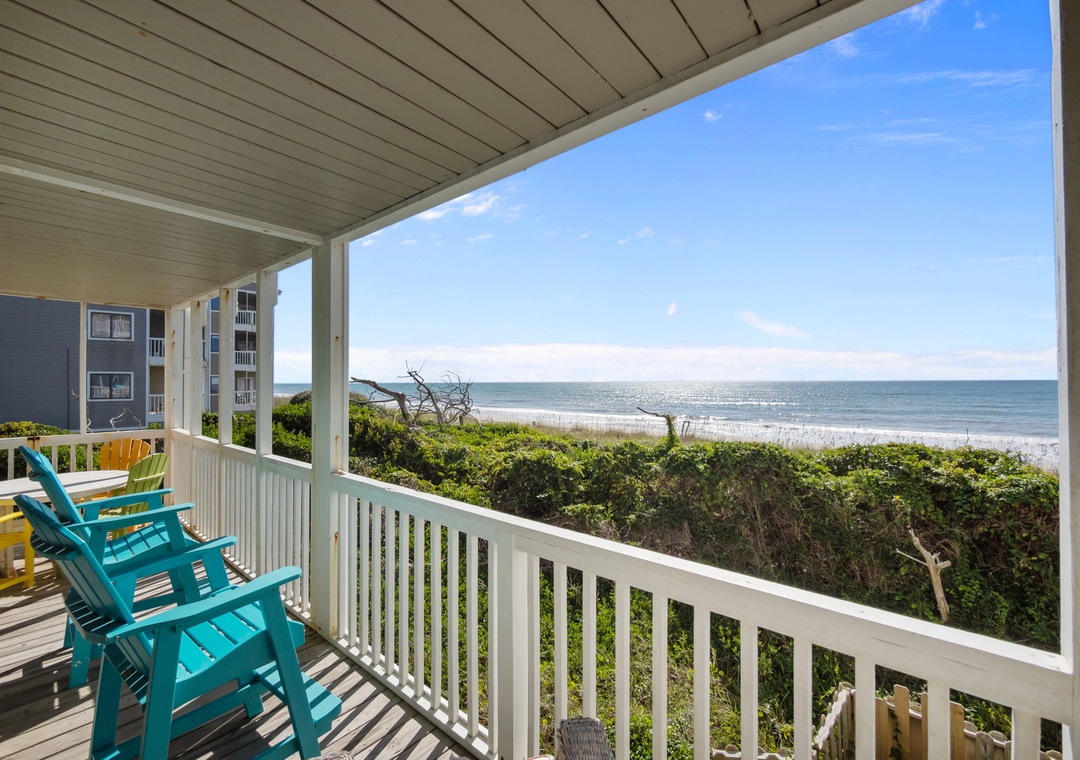 Relax in colorful beach chairs on your private covered deck overlooking pristine shoreline and endless ocean views.
