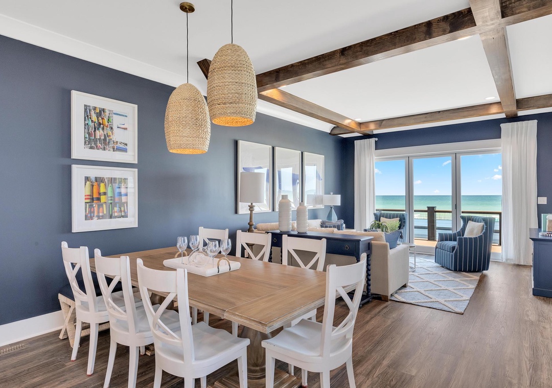 Gather around this coastal dining table with stunning ocean views just steps away. Natural light fills the space, while the open-concept layout invites you to relax and savor every moment.