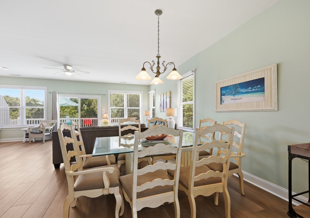 Gather around your coastal-inspired dining space, where soft sea colors meet abundant natural light. Large windows frame peaceful neighborhood views while you enjoy meals together.