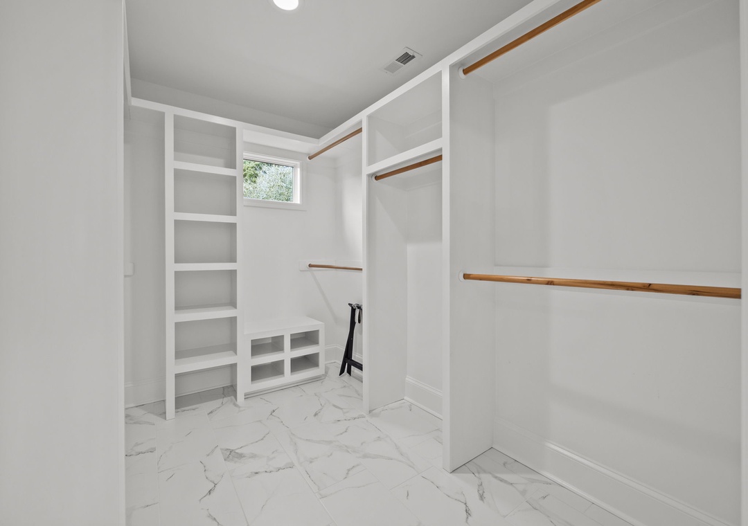 Your spacious walk-in closet features custom built-in shelving and hanging rods, giving you plenty of organized storage for all your belongings.