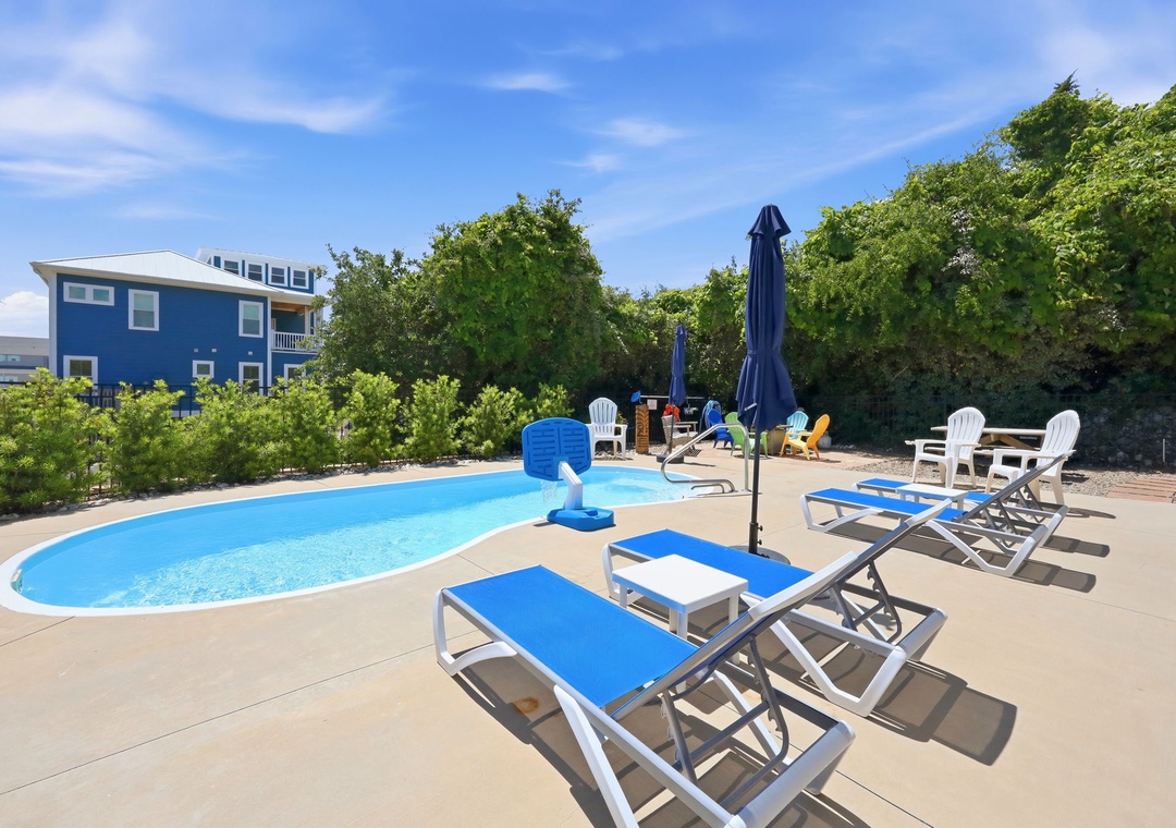 Your private pool awaits, surrounded by lounge chairs and shaded seating. Soak up the sun, take a refreshing dip, and unwind in this inviting outdoor oasis framed by lush greenery.