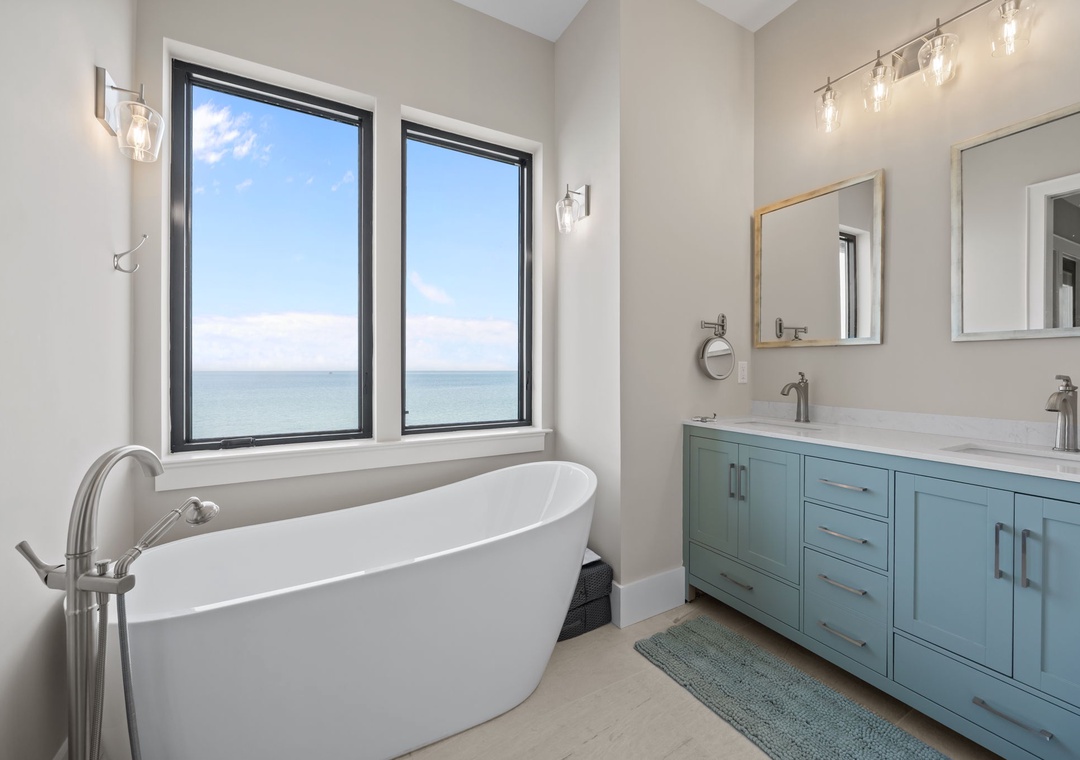 Soak in your private spa-like sanctuary with stunning ocean views. The elegant soaking tub and dual vanities create the perfect retreat.