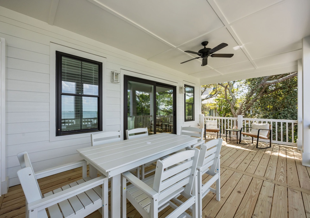 Your spacious covered deck offers the perfect spot for outdoor dining with comfortable seating and gentle breezes from the ceiling fan.