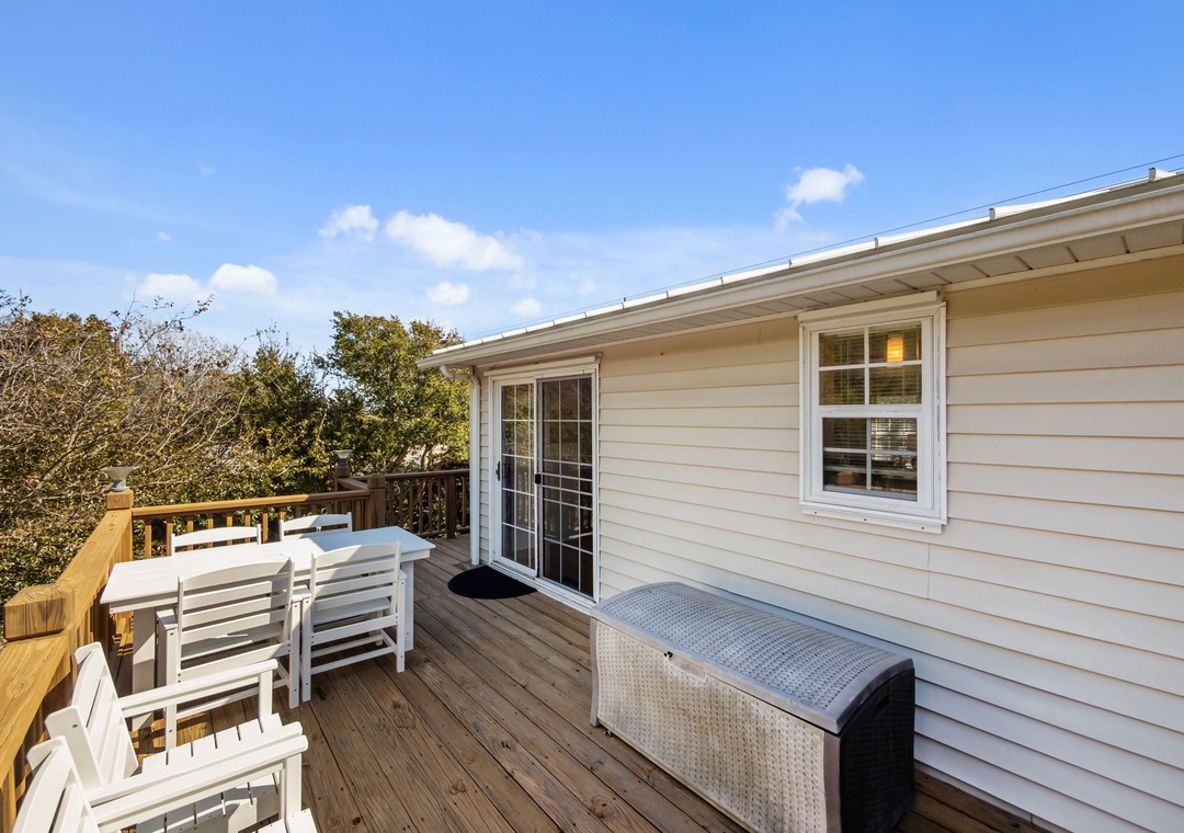 Step onto your private deck with outdoor seating and storage, perfect for morning coffee under the blue sky.