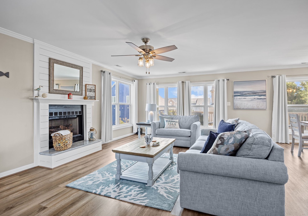Sink into plush sofas by your cozy fireplace while natural light streams through multiple windows, creating the perfect retreat.