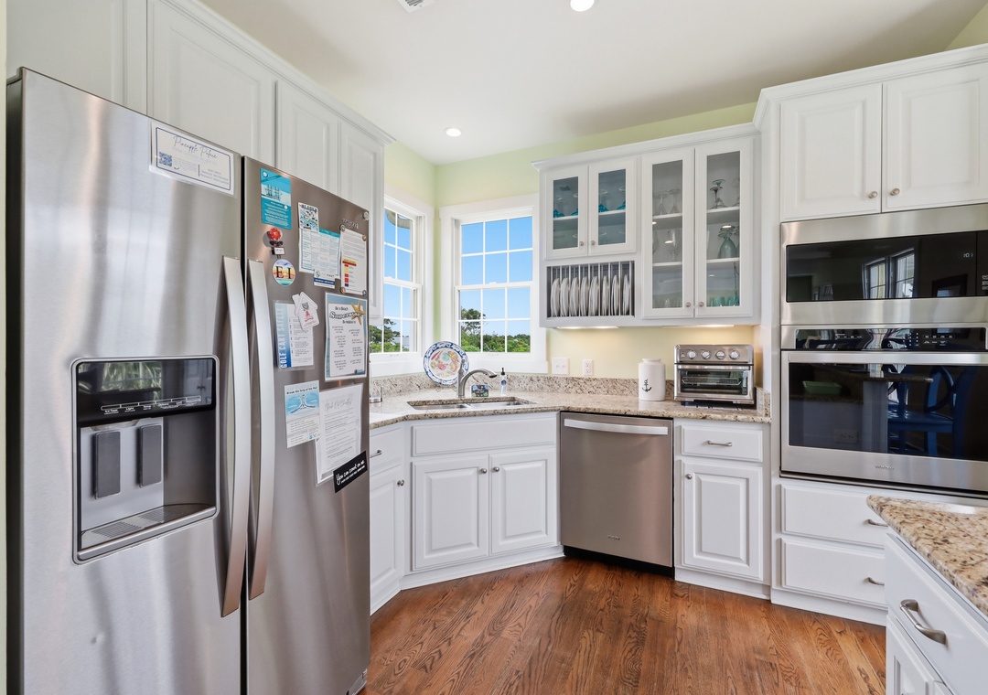 Your fully equipped kitchen features stainless steel appliances, granite countertops, and bright natural light—perfect for preparing family meals together during your stay.