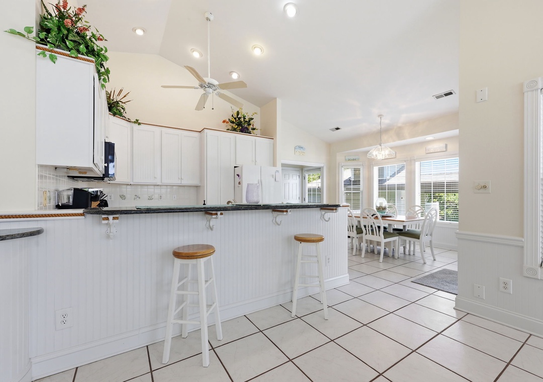Bright, open kitchen with breakfast bar seating flows into your dining space—perfect for morning coffee or casual meals with loved ones.