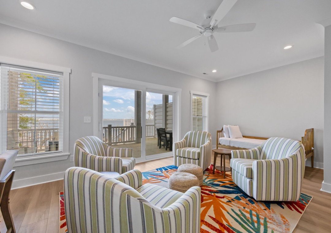 Relax in your bright living space with stylish striped chairs and colorful decor, while enjoying direct access to your private outdoor deck.