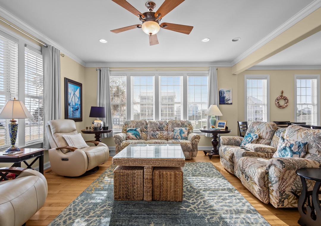 Relax in your spacious living room with panoramic city views, comfortable seating, and elegant coastal decor that makes you feel right at home.