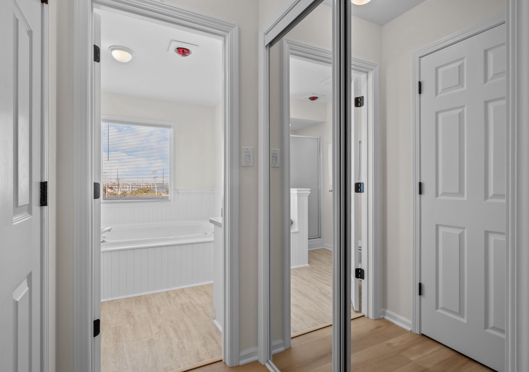 Your spacious bedroom suite features a luxurious soaking tub positioned perfectly beside the window, where you can unwind while taking in scenic views.