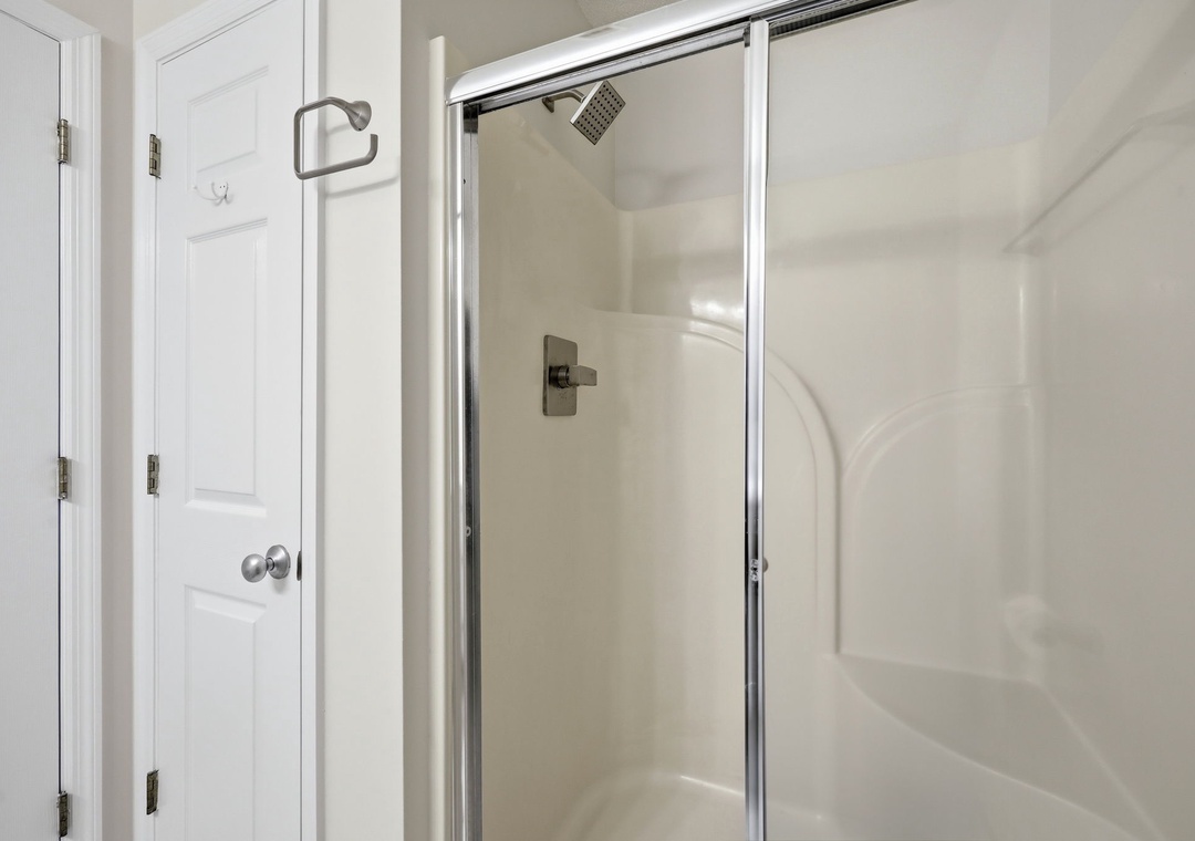 Step into your private shower with a sleek glass enclosure and modern fixtures, perfect for refreshing after a day of adventure.