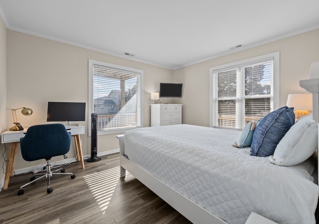 You'll love this bright bedroom with a comfy queen bed, workspace desk, and streaming-ready TV for ultimate relaxation.