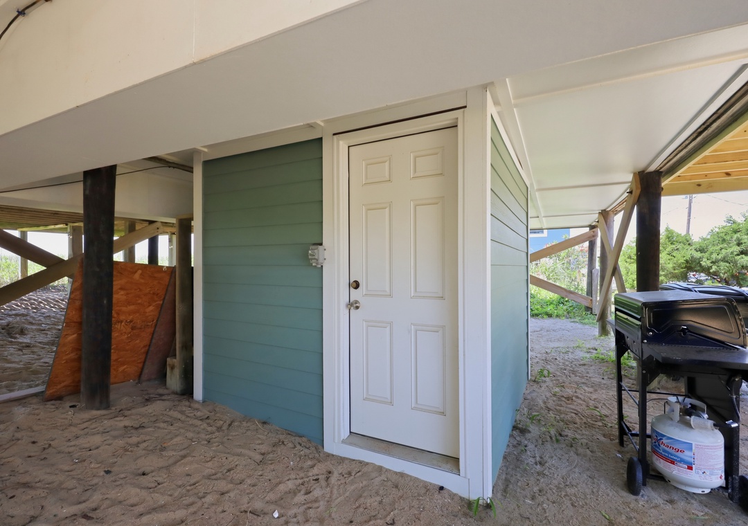 A covered beachfront patio with direct access to the sand, BBQ grill ready for your seaside cookouts, and storage for your beach gear.