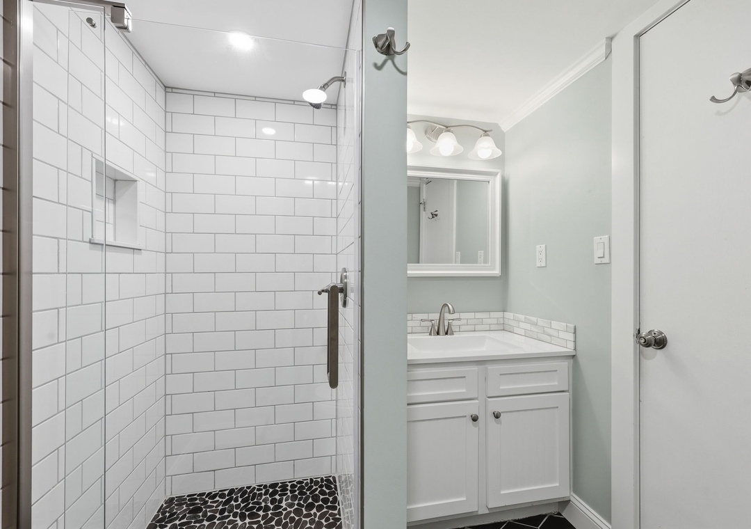 Refresh after your adventures in this pristine bathroom, featuring a spacious subway-tiled shower and modern vanity with all the essentials for your comfort.