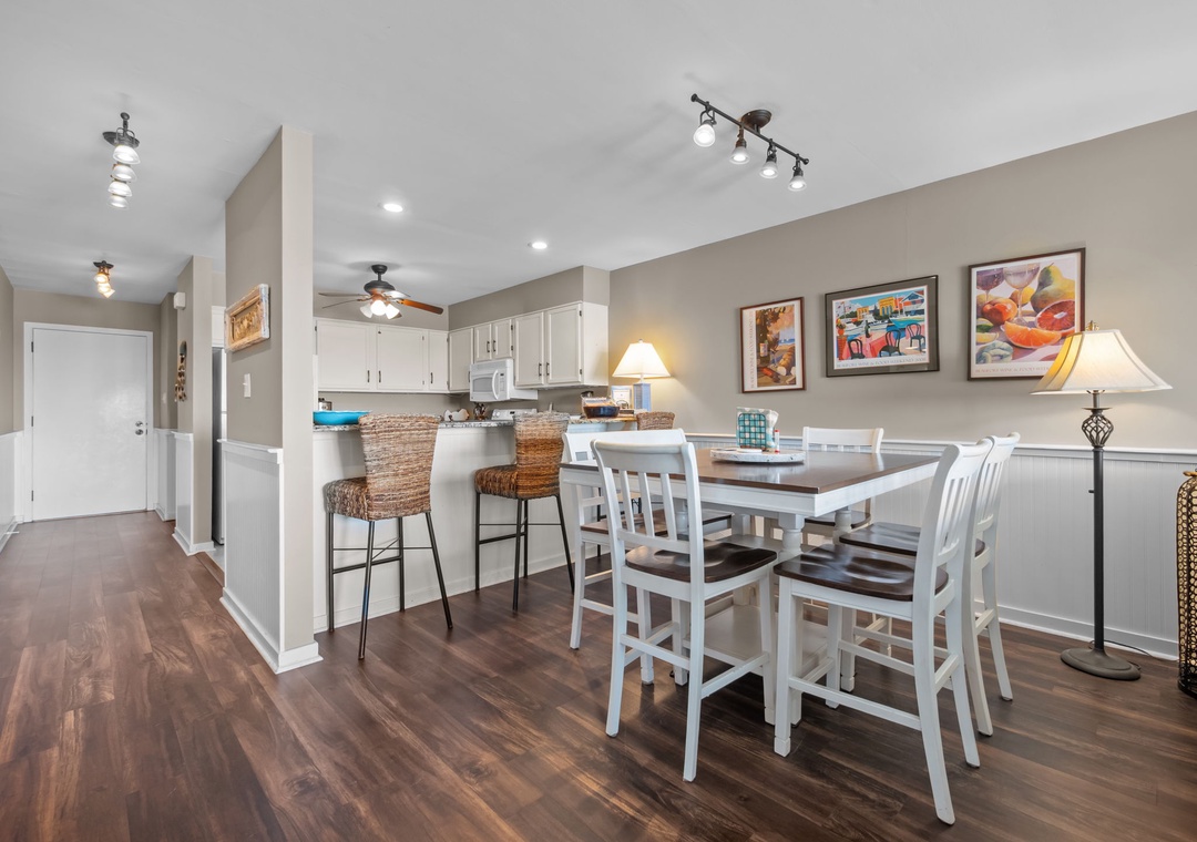 Gather around your spacious dining table for memorable meals, while the open kitchen invites culinary adventures with modern appliances and breakfast bar seating.