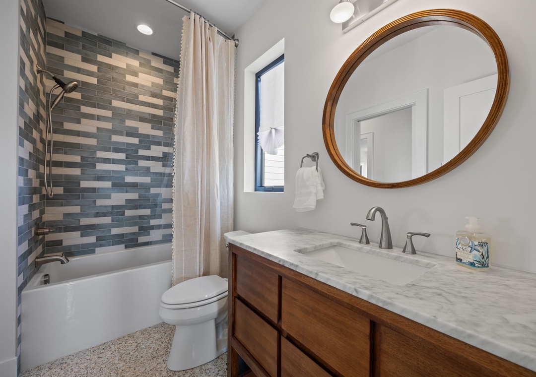 Unwind in your stylishly appointed bathroom featuring elegant marble countertops, soothing tile accents, and a relaxing tub for rejuvenating soaks.