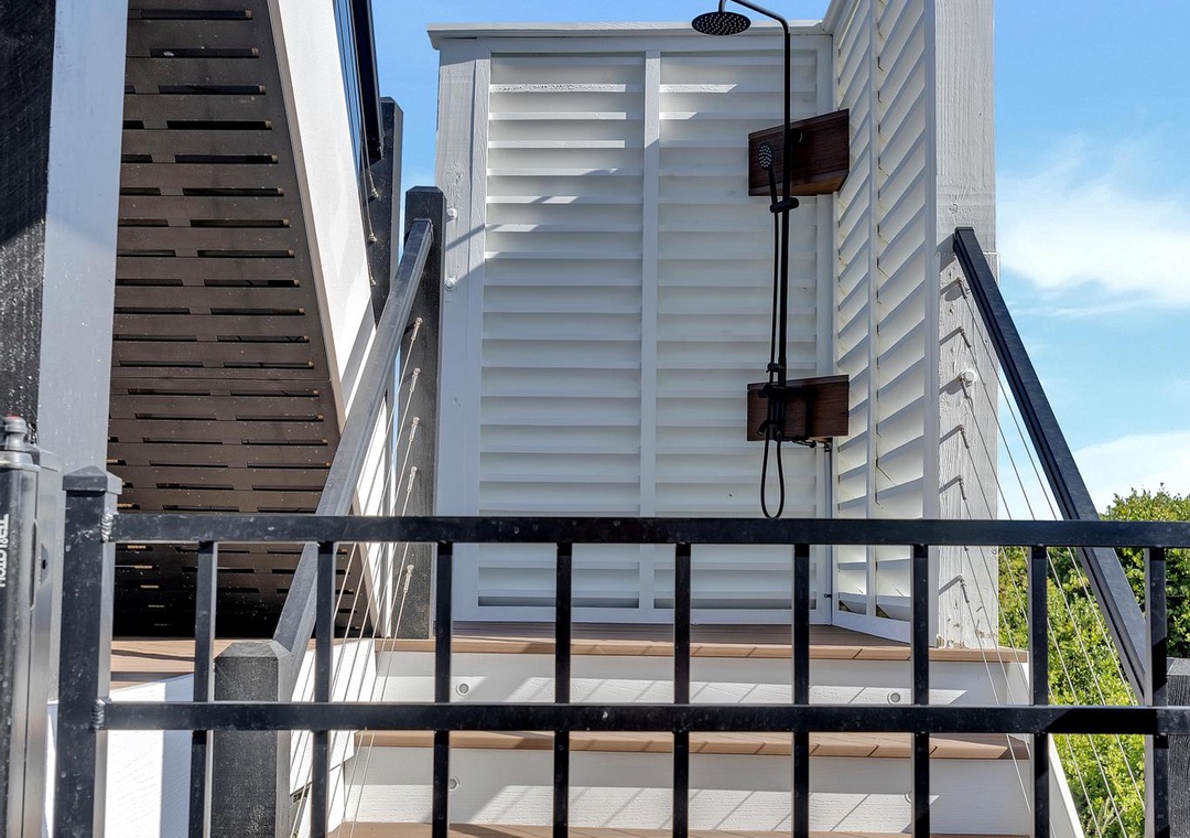 Private outdoor shower with natural light and modern privacy screens, perfect for rinsing off after the beach or pool.