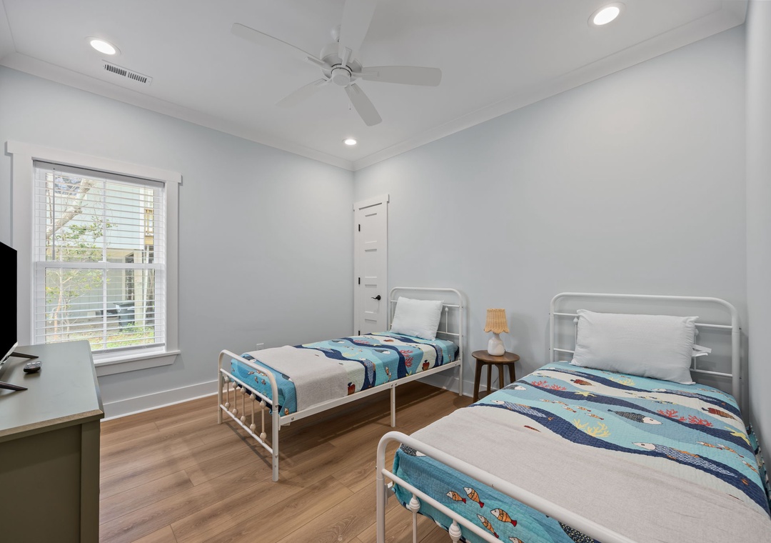 Your bright twin bedroom offers comfortable single beds with cheerful linens, perfect for kids or friends traveling together.