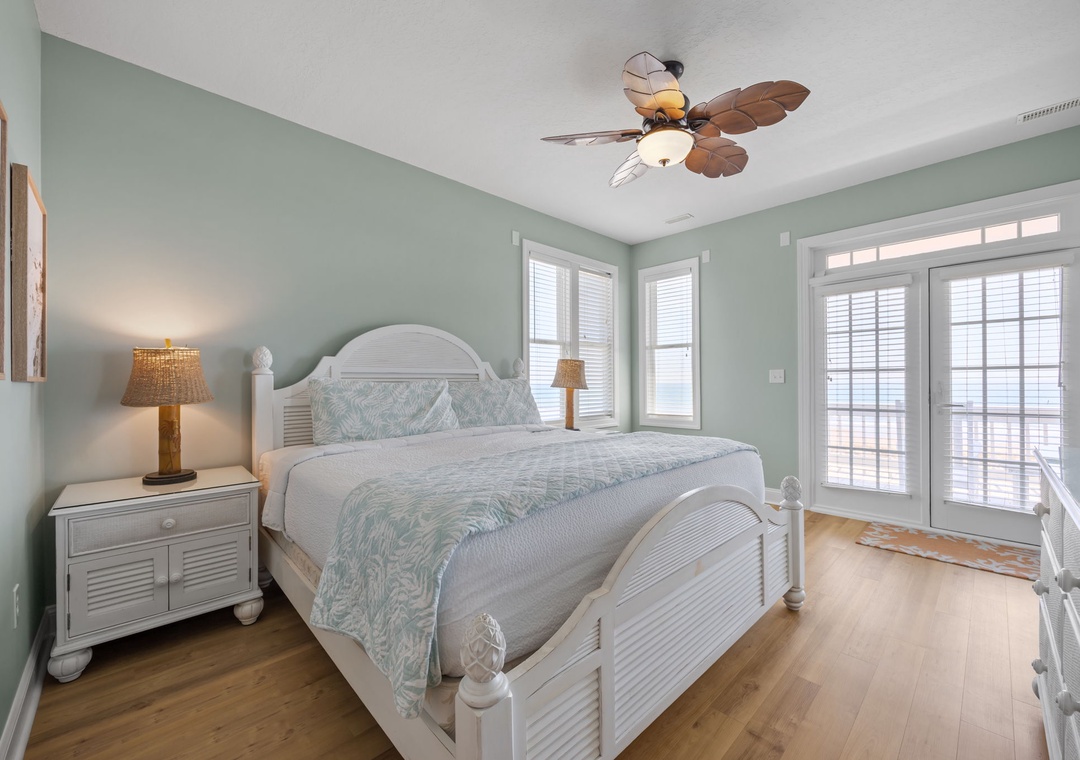 Drift into peaceful sleep in your coastal bedroom with tropical ceiling fan and French doors opening to your private balcony.
