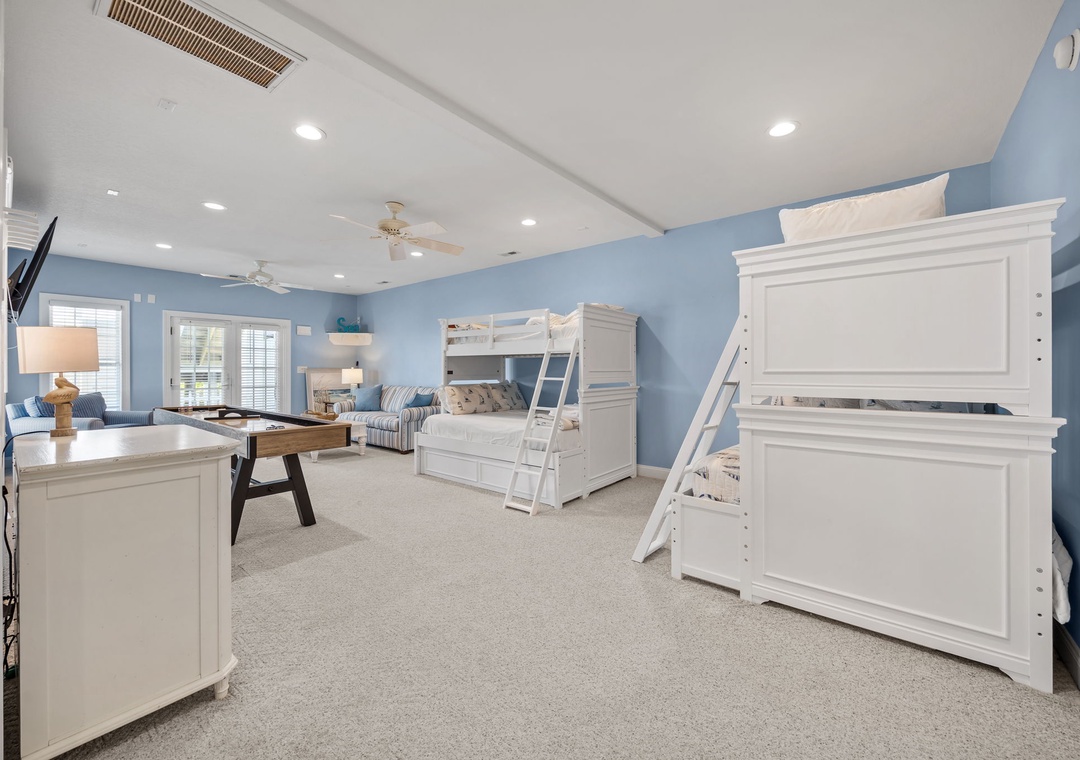 Your family's coastal retreat features bunk beds for the kids, with soft blue walls and ample space for everyone to unwind together.