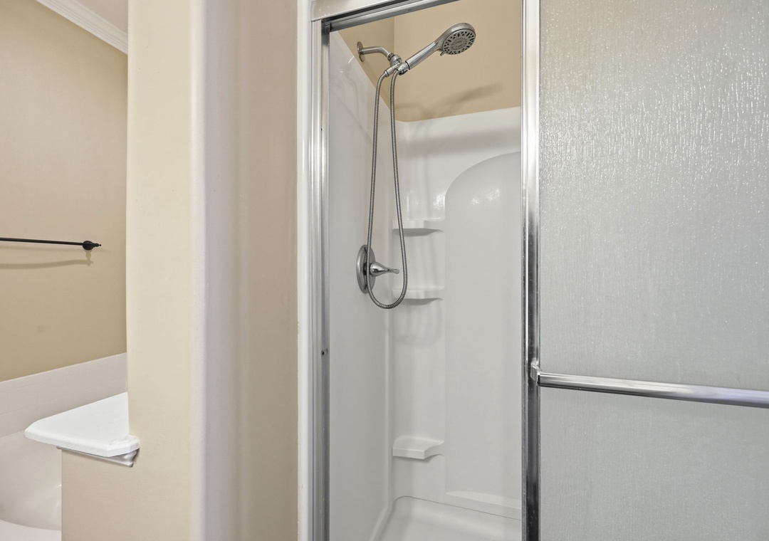 Step into this clean, bright shower with a handheld showerhead and built-in niches for your toiletries—your perfect morning refresh awaits.