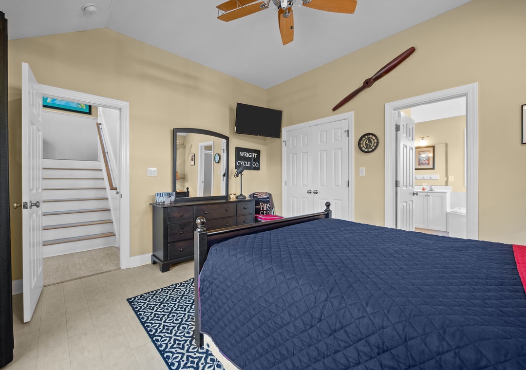 Your bright bedroom features a ceiling fan, TV, and private bathroom for ultimate comfort during your stay.