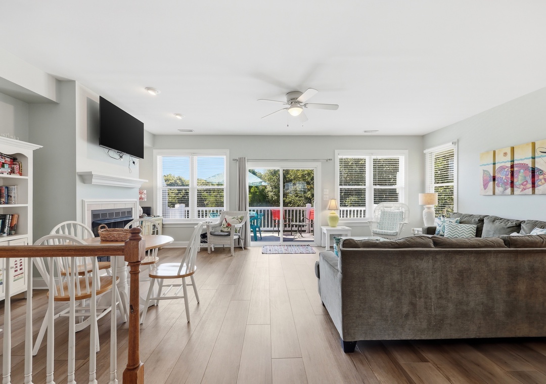 Relax in your bright, open living space with dining, comfortable seating, and a fireplace for cozy evenings. Sliding doors reveal a balcony with lounge chairs awaiting your morning coffee.