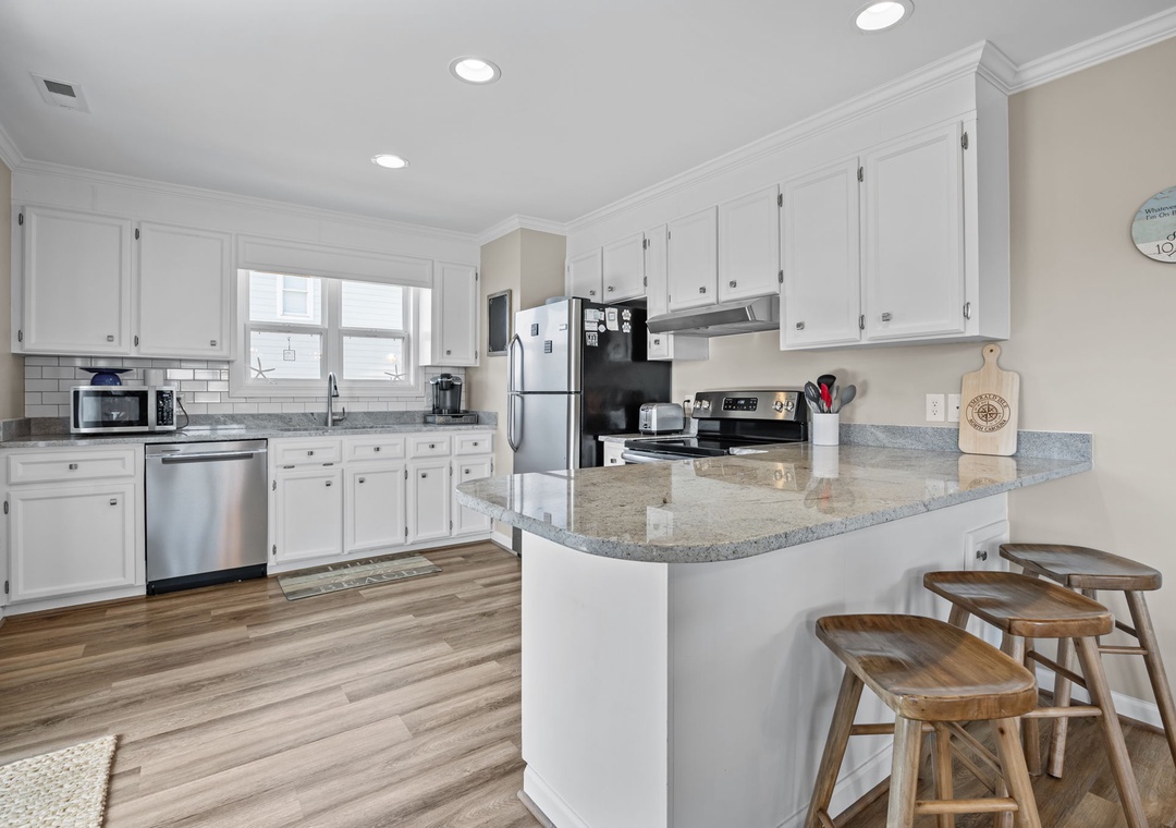 Your spacious kitchen features granite countertops, modern appliances, and a breakfast bar where you'll love sipping morning coffee.