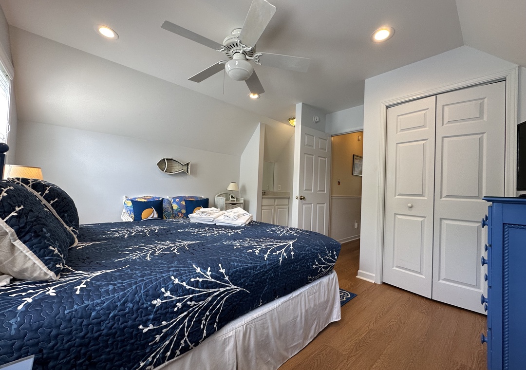 Unwind in your cozy bedroom with nautical touches, a ceiling fan, and ample closet space—your seaside retreat awaits.