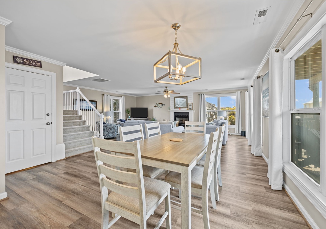 Gather around your spacious dining table while natural light streams through floor-to-ceiling windows, creating the perfect setting for memorable meals together.