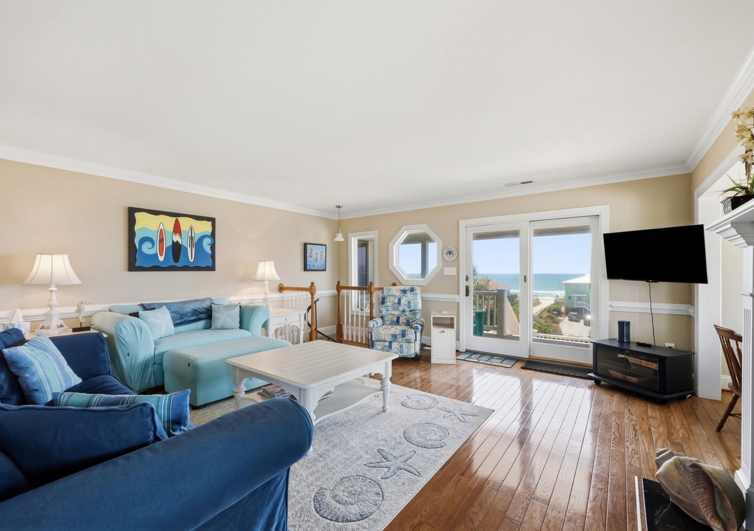 Sink into plush coastal-blue furnishings while ocean waves shimmer through picture windows. Your private beachfront living room invites barefoot relaxation and peaceful mornings with coffee.