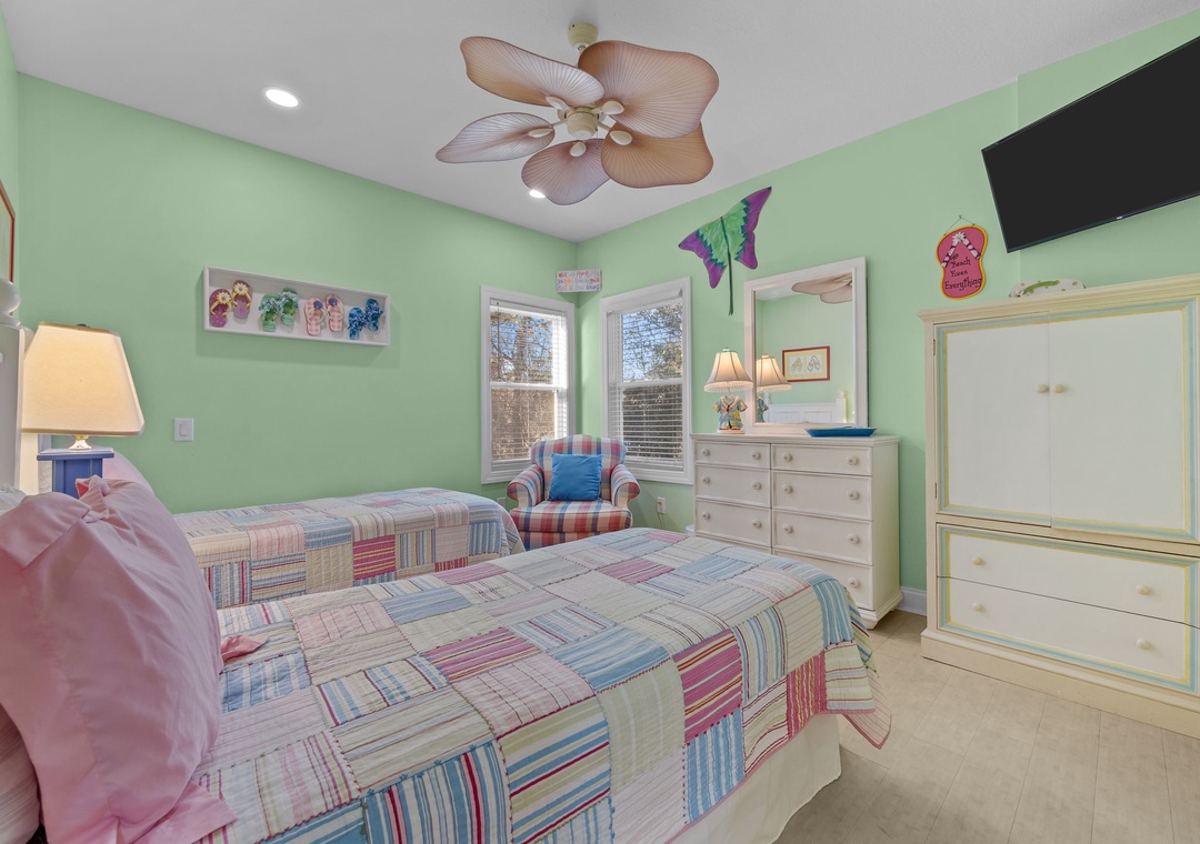 Your peaceful bedroom features comfortable bedding, tropical ceiling fan, and sunny windows for natural light and relaxing views.