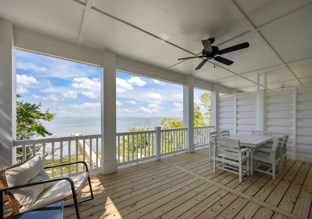 Sip your morning coffee while soaking in stunning water views from this peaceful screened porch with comfortable seating.