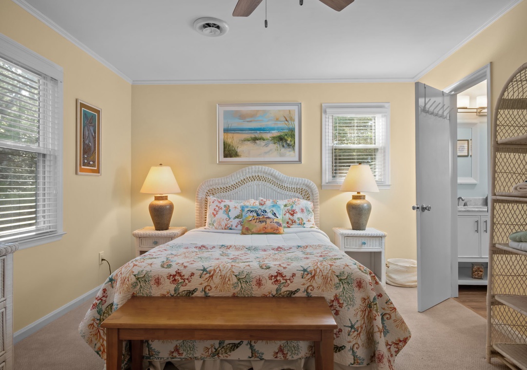 Drift off peacefully in your charming coastal bedroom, where warm yellow walls and tropical florals create a soothing beach house atmosphere.