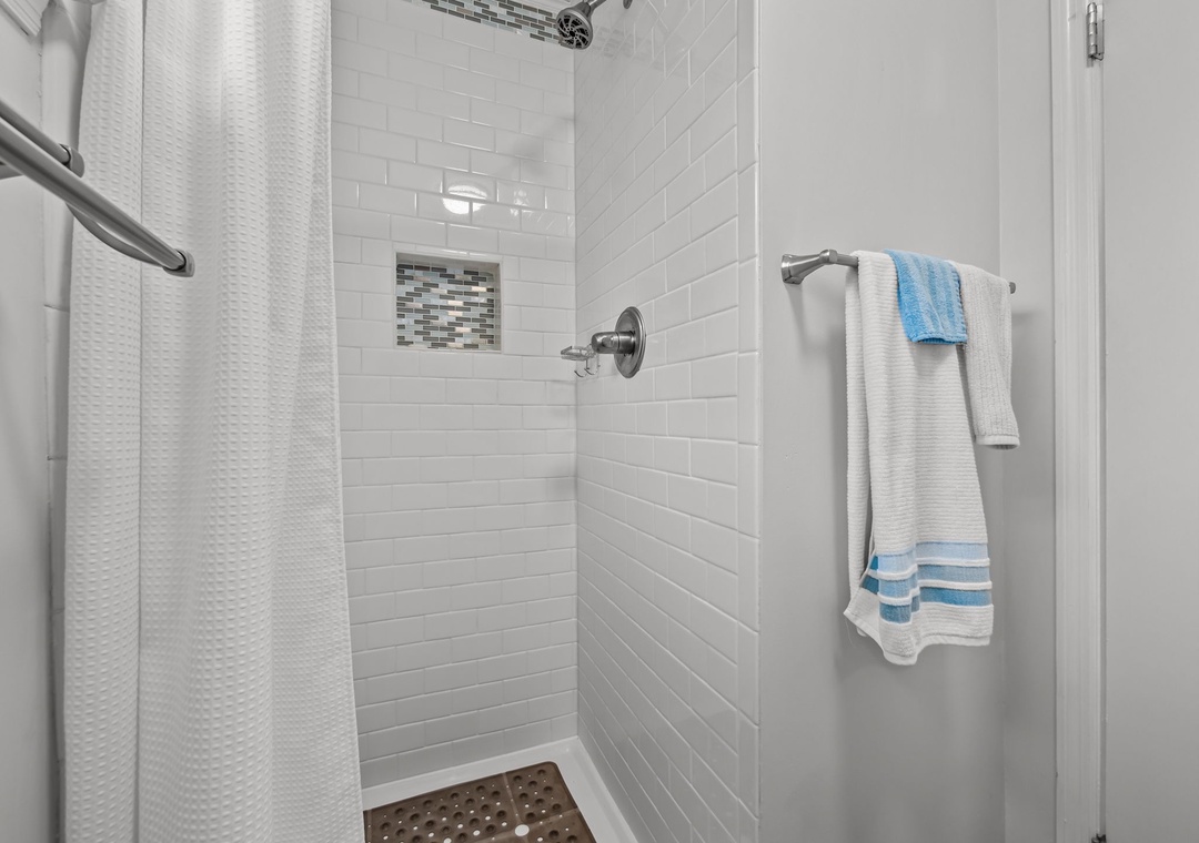 Step into your refreshing shower with elegant subway tiles and modern fixtures, perfectly designed for your comfort.