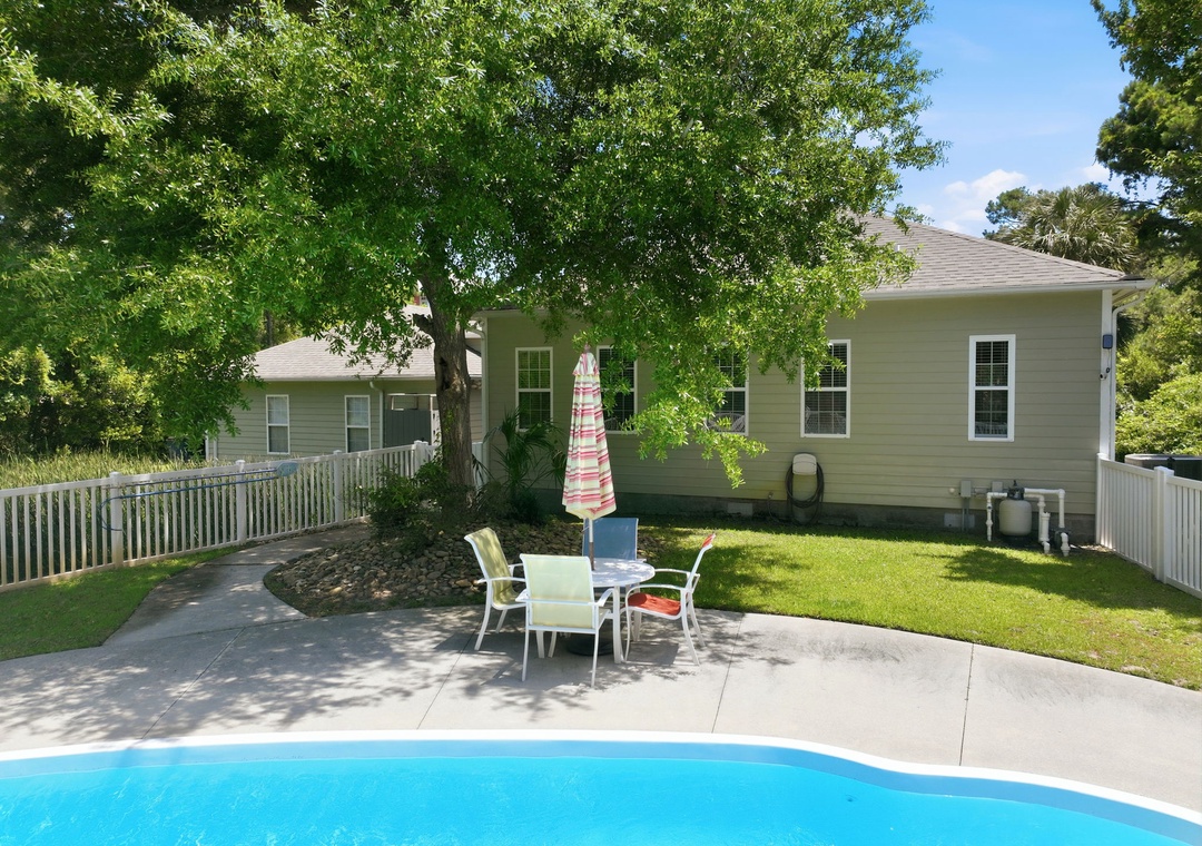 Enjoy sunny afternoons by your private pool, with plenty of patio seating under the shade of a mature tree and a spacious, fenced backyard for ultimate relaxation.